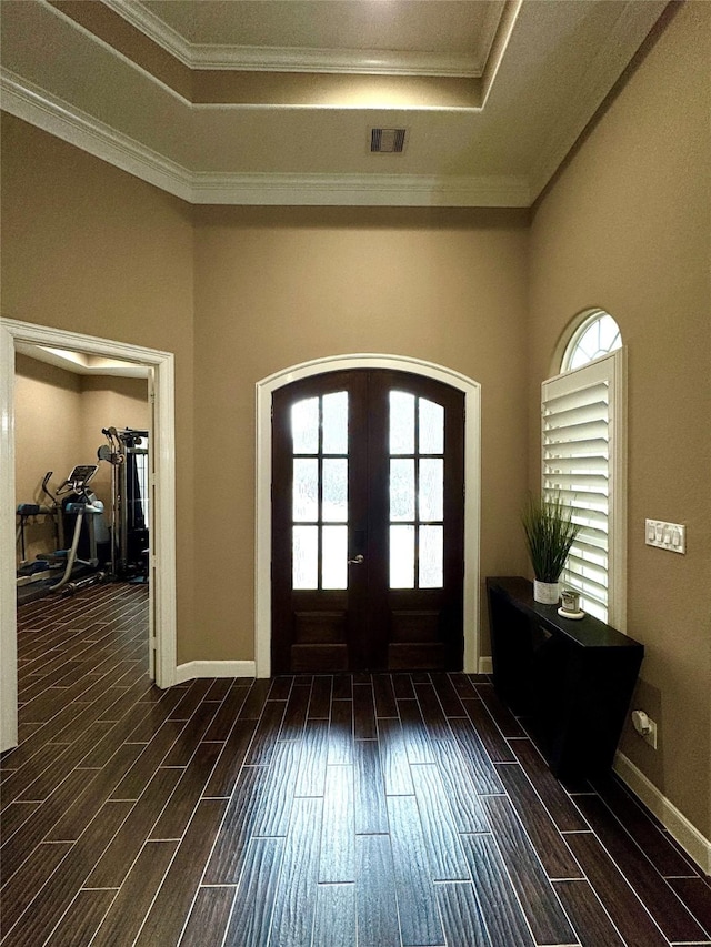 entrance foyer with a tray ceiling, french doors, visible vents, and wood tiled floor