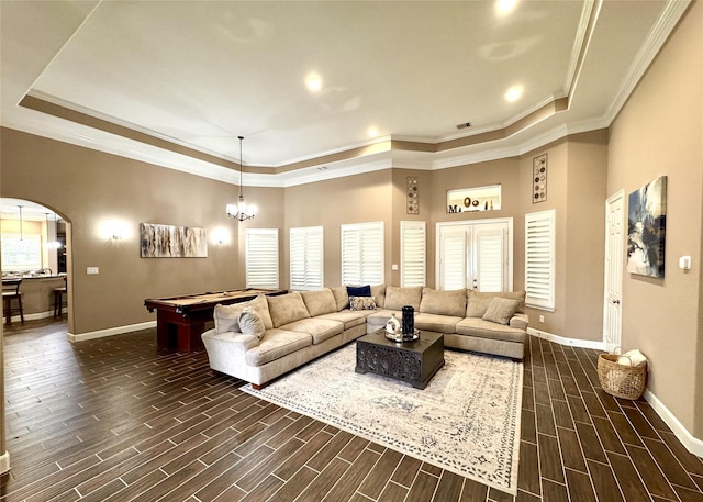 18315 Wisp Willow Way, Porter, TX 77365 - living room featuring arched walkways, wood finish floors, baseboards, and a tray ceiling