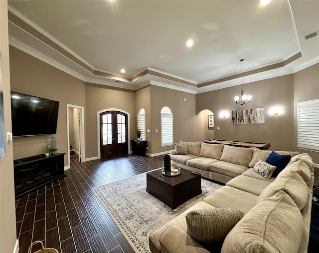 18315 Wisp Willow Way, Porter, TX 77365 - living room featuring visible vents, wood finish floors, arched walkways, french doors, and a raised ceiling
