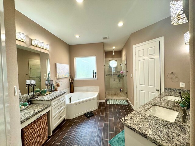 18315 Wisp Willow Way, Porter, TX 77365 - full bath featuring visible vents, a shower stall, wood finish floors, a bath, and a sink