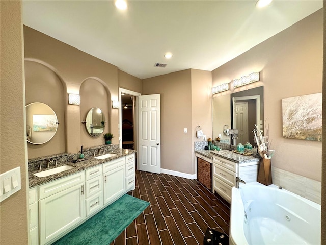 18315 Wisp Willow Way, Porter, TX 77365 - bathroom with double vanity, wood finish floors, baseboards, and a sink