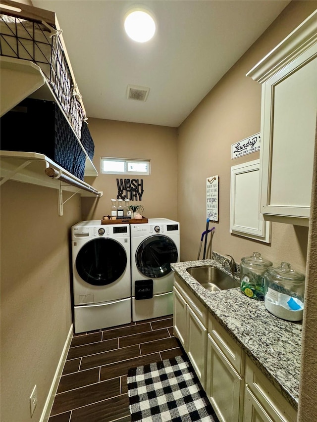 18315 Wisp Willow Way, Porter, TX 77365 - laundry room with visible vents, a sink, cabinet space, separate washer and dryer, and wood tiled floor