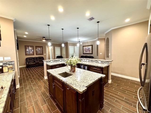 18315 Wisp Willow Way, Porter, TX 77365 - kitchen with a spacious island, visible vents, wood finish floors, open floor plan, and freestanding refrigerator