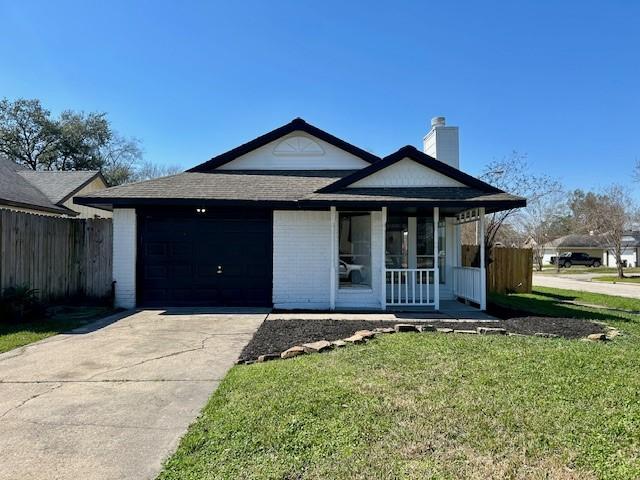 ranch-style home featuring concrete driveway, covered porch, an attached garage, a front yard, and fence