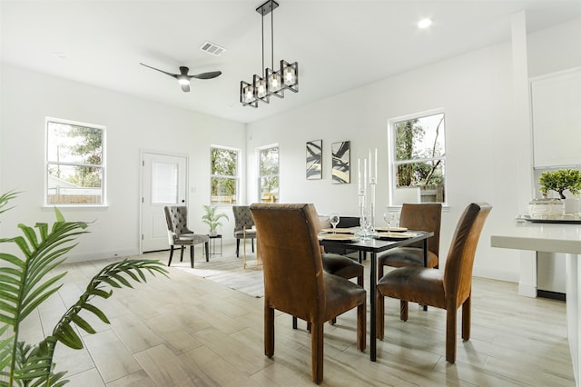 dining space with light wood-style flooring, recessed lighting, a ceiling fan, visible vents, and baseboards