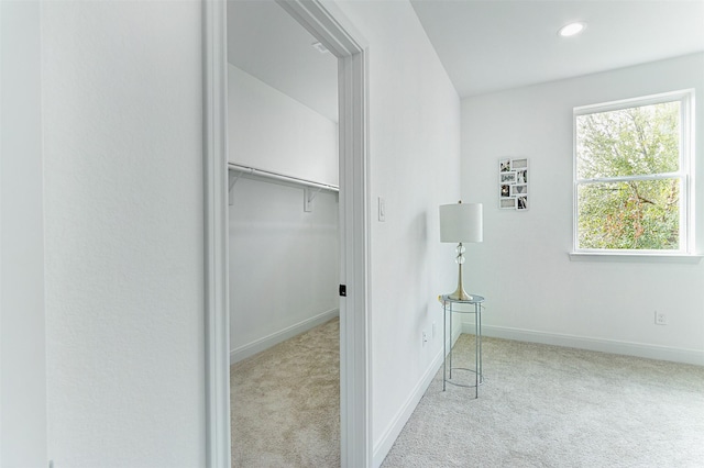 clothes washing area with recessed lighting, light carpet, and baseboards