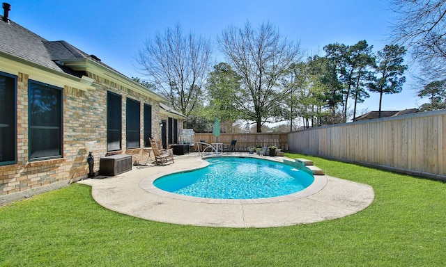 view of pool with a fenced in pool, a patio area, a fenced backyard, and a yard