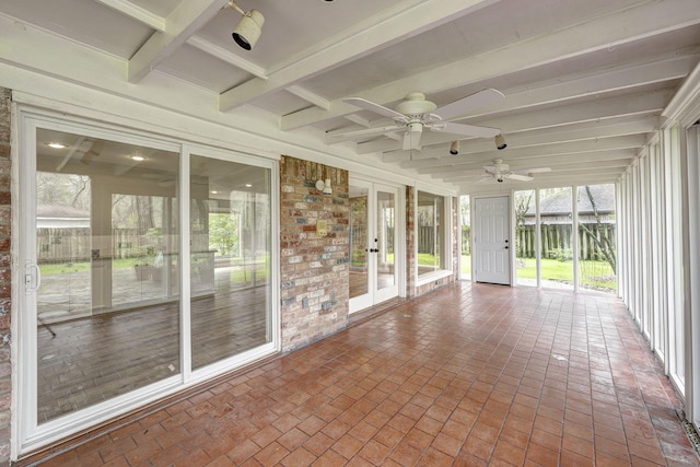 unfurnished sunroom featuring beam ceiling and ceiling fan