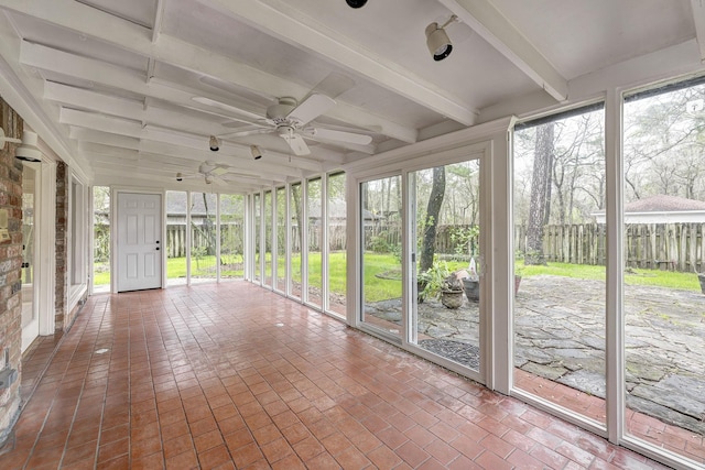 unfurnished sunroom with beamed ceiling, a healthy amount of sunlight, and ceiling fan