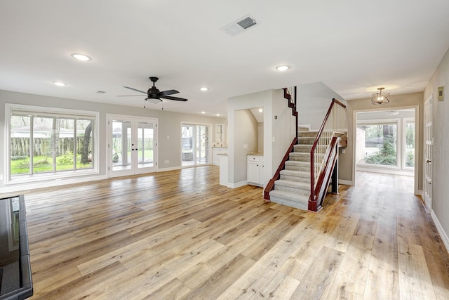 unfurnished living room featuring stairs, recessed lighting, light wood-style floors, and visible vents