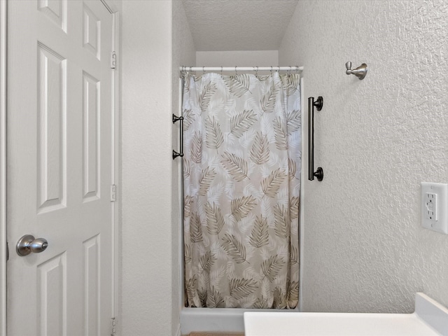 1206 Middle Dr W, Surfside Beach, TX 77541 - bathroom with a shower with curtain, a textured ceiling, and a textured wall
