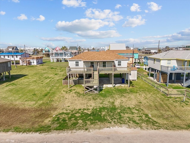 1206 Middle Dr W, Surfside Beach, TX 77541 - rear view of house with a wooden deck, a shingled roof, and a residential view