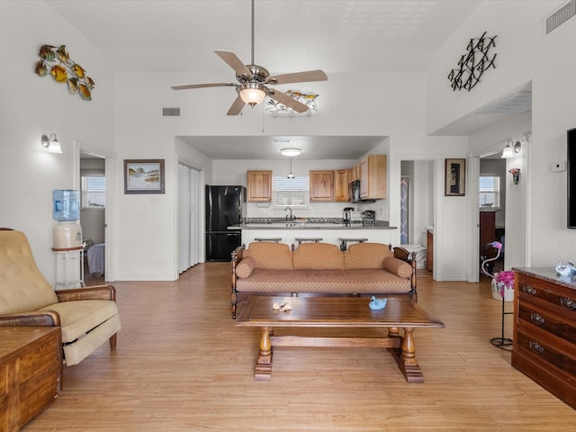 1206 Middle Dr W, Surfside Beach, TX 77541 - living room with high vaulted ceiling, a ceiling fan, and light wood-type flooring