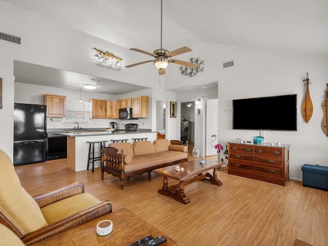1206 Middle Dr W, Surfside Beach, TX 77541 - living room with light wood-style flooring, a ceiling fan, and high vaulted ceiling