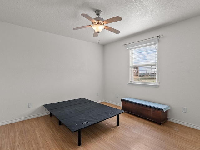 1206 Middle Dr W, Surfside Beach, TX 77541 - living area featuring wood finished floors, a ceiling fan, and a textured ceiling