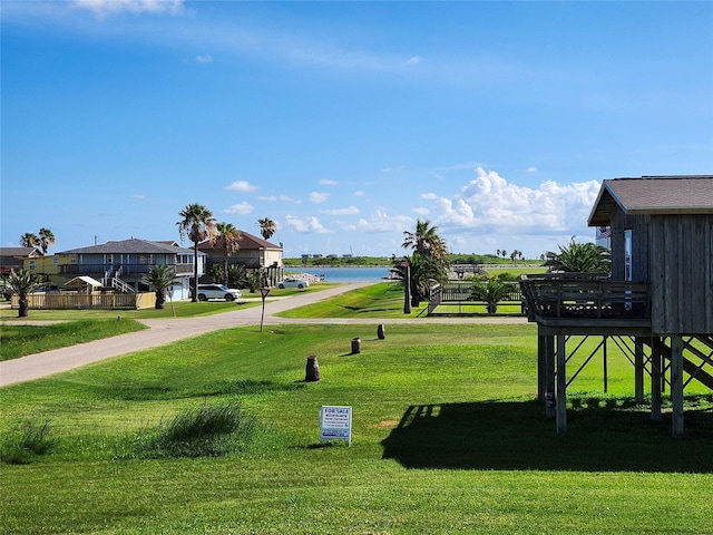 1206 Middle Dr W, Surfside Beach, TX 77541 - view of home's community featuring a lawn and a water view