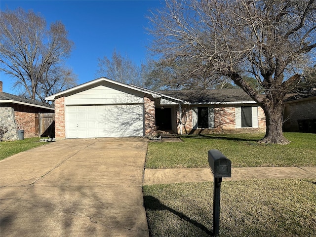 view of front of home featuring driveway, a front lawn, an attached garage, and brick siding