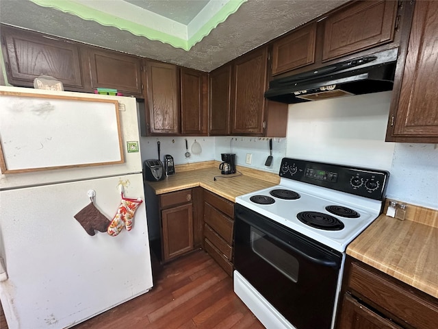 kitchen featuring dark wood-style floors, light countertops, electric range oven, freestanding refrigerator, and under cabinet range hood