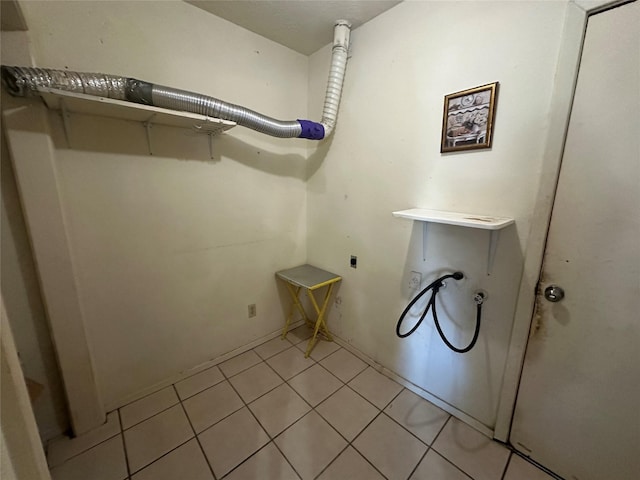 laundry area featuring hookup for a washing machine, laundry area, hookup for an electric dryer, and light tile patterned floors