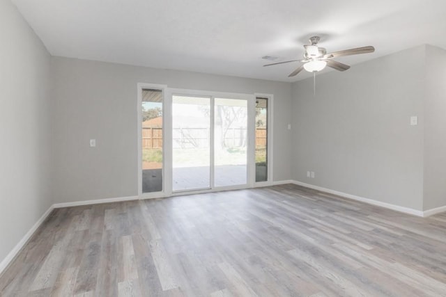 laundry area with laundry area, hookup for a washing machine, wood finished floors, and baseboards