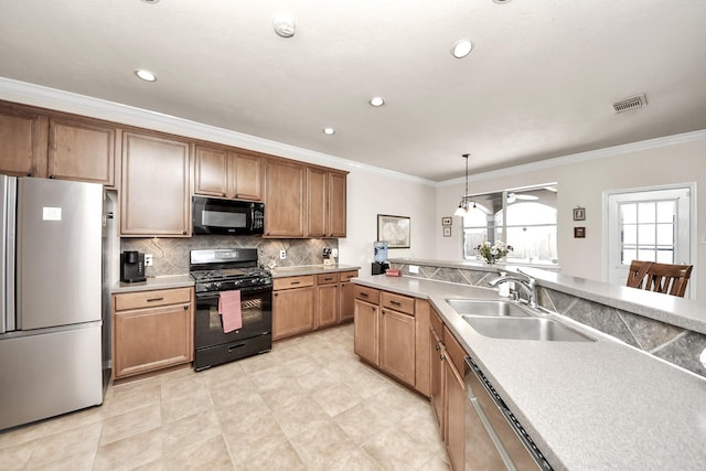 kitchen with visible vents, decorative light fixtures, light countertops, black appliances, and a sink