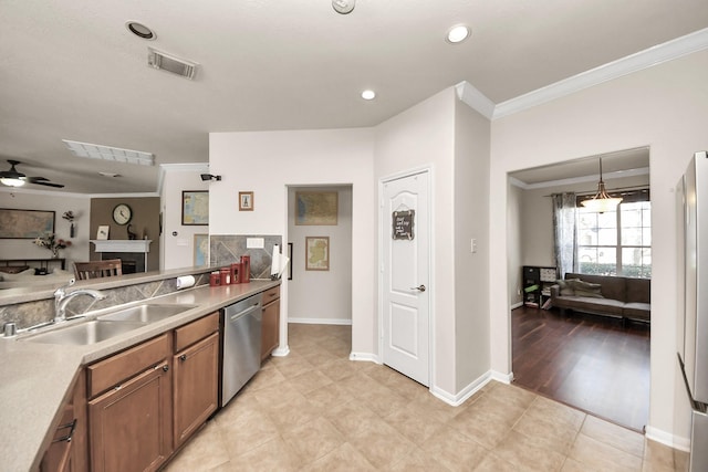 kitchen with brown cabinets, open floor plan, a sink, pendant lighting, and stainless steel dishwasher