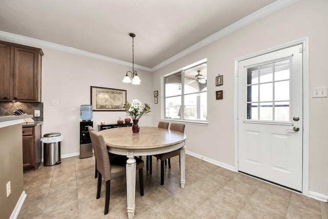 dining area featuring baseboards, light tile patterned flooring, a notable chandelier, and crown molding