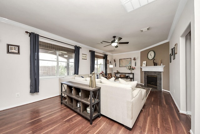 living room with a ceiling fan, visible vents, dark wood finished floors, and a tiled fireplace