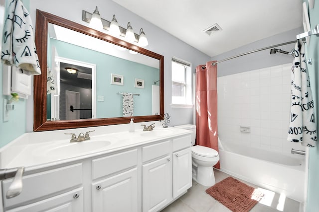 bathroom featuring shower / bath combo, visible vents, a sink, and tile patterned floors