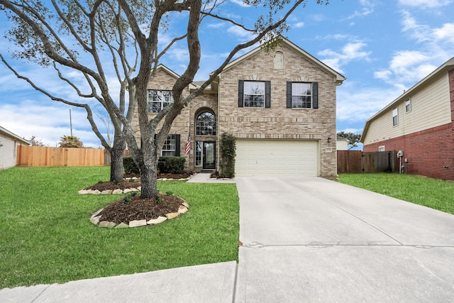 traditional-style home featuring a front yard, fence, concrete driveway, and brick siding