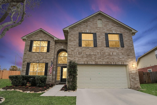 traditional home featuring a garage, fence, and brick siding