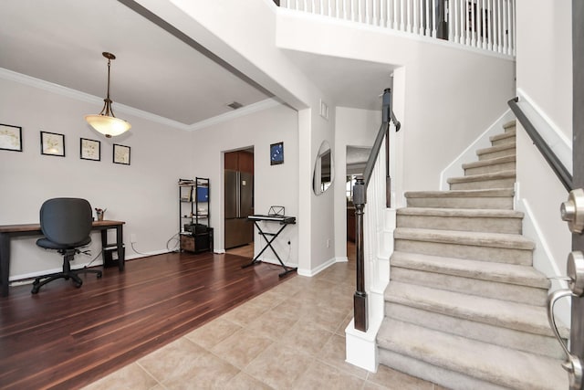 interior space with visible vents, crown molding, stairway, and baseboards