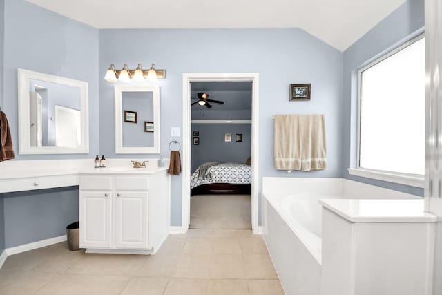 bathroom featuring a garden tub, vaulted ceiling, vanity, ensuite bath, and tile patterned floors