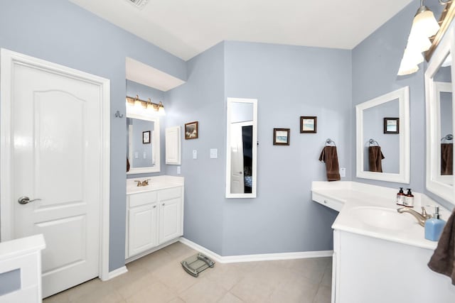 bathroom featuring two vanities, a sink, tile patterned flooring, and baseboards