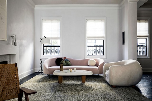 living room with plenty of natural light, a high end fireplace, and crown molding