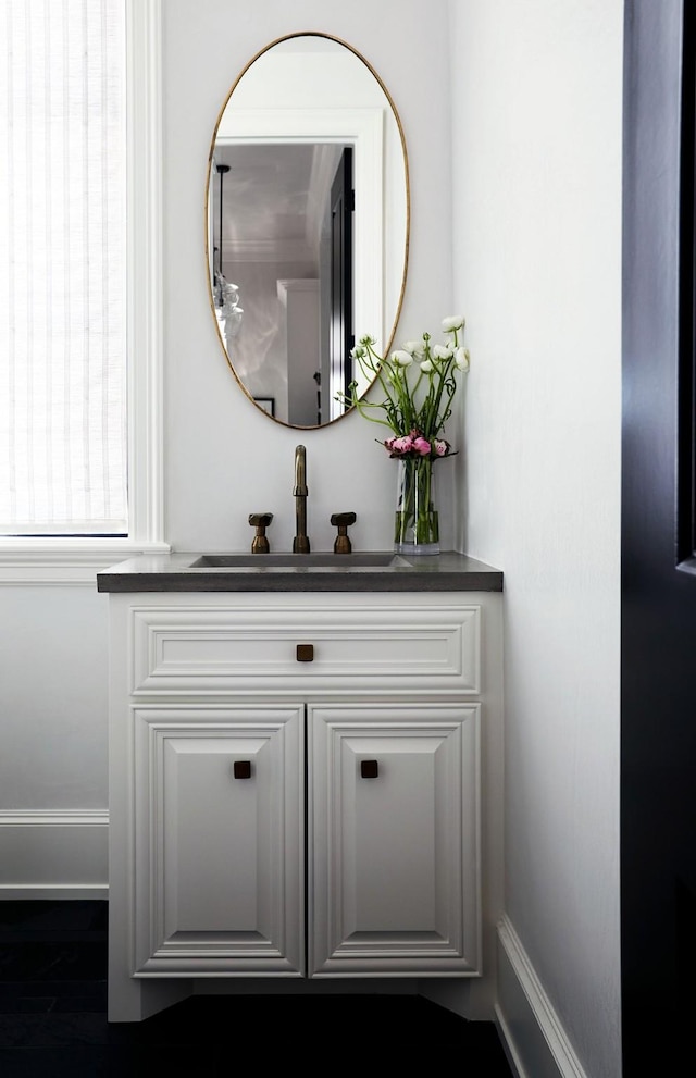 interior details with wood finished floors and vanity