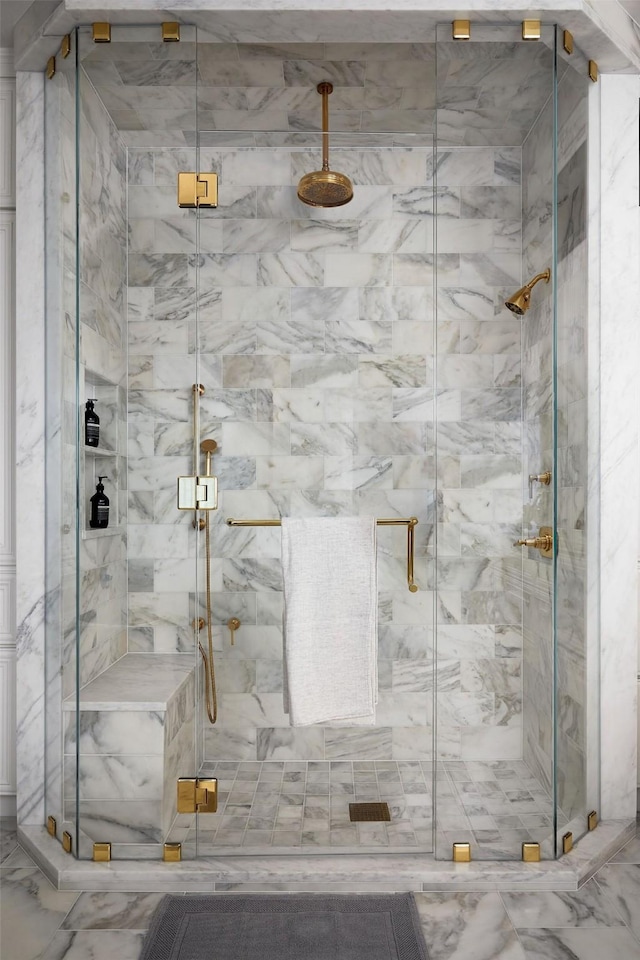 full bathroom with a marble finish shower