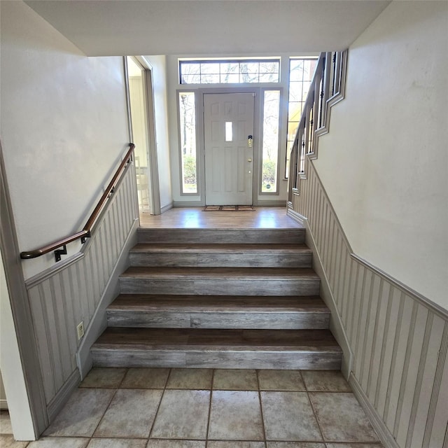 staircase featuring wainscoting