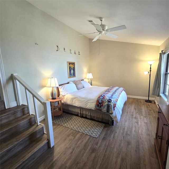 bedroom featuring ceiling fan, baseboards, visible vents, and wood finished floors