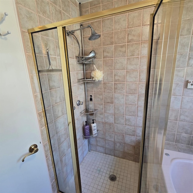bathroom with a shower stall and a tub to relax in
