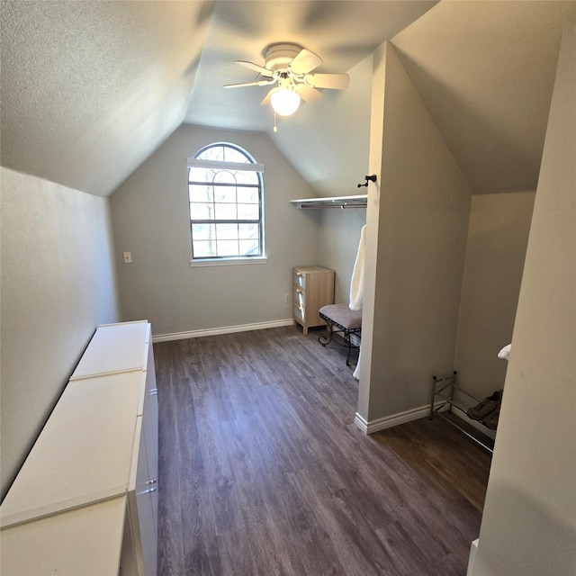 bonus room with baseboards, ceiling fan, lofted ceiling, and dark wood-type flooring