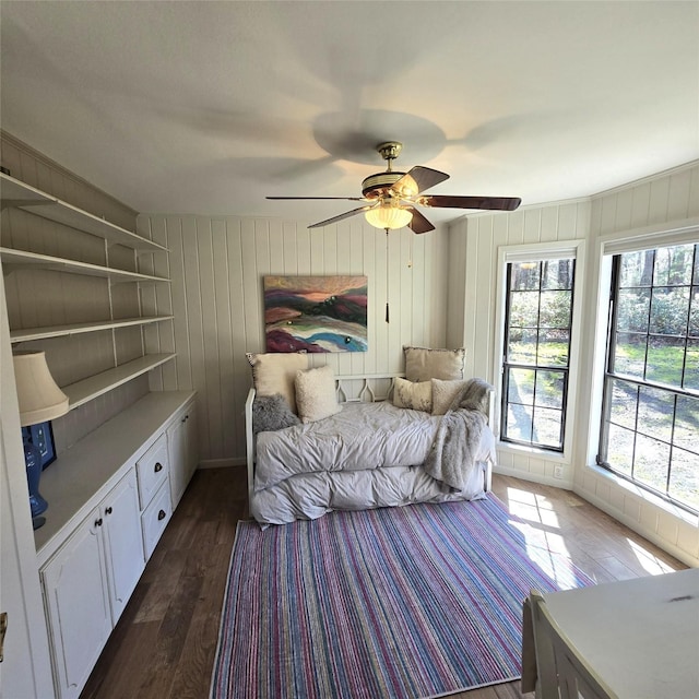 bedroom featuring a ceiling fan and dark wood-style floors