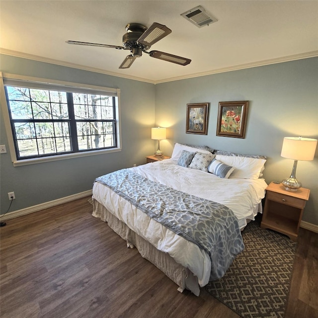 bedroom featuring multiple windows, wood finished floors, and visible vents