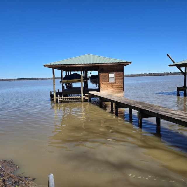 view of dock featuring boat lift and a water view