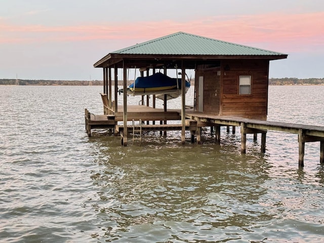 view of dock with boat lift and a water view