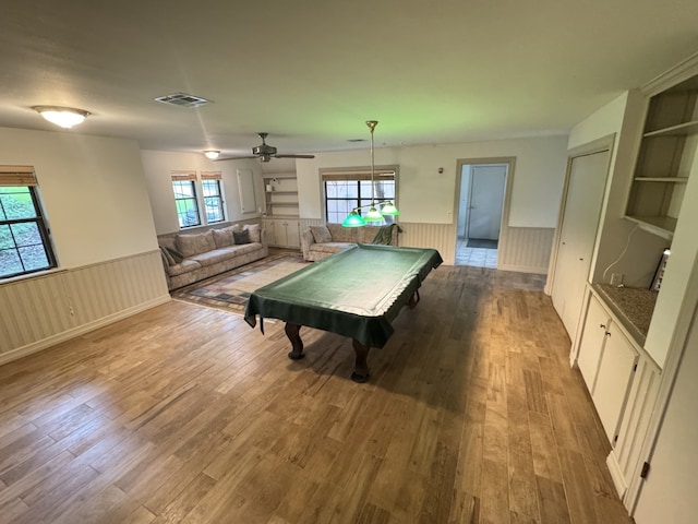 game room with ceiling fan, wainscoting, wood finished floors, and billiards