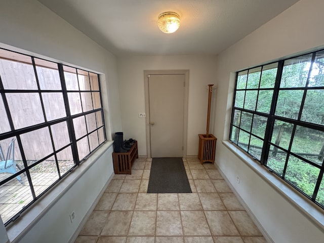 entryway featuring plenty of natural light and baseboards
