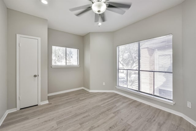 empty room with ceiling fan, light wood finished floors, recessed lighting, and baseboards