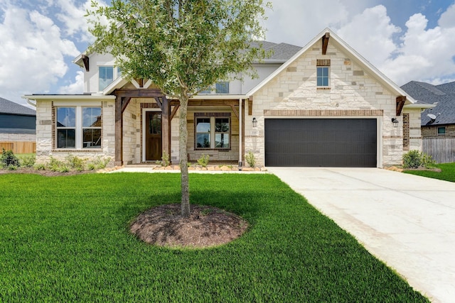 view of front of house featuring fence, a garage, stone siding, driveway, and a front lawn