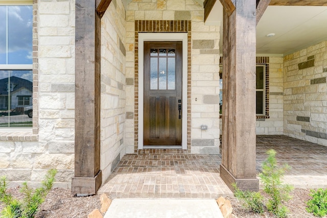 entrance to property featuring stone siding